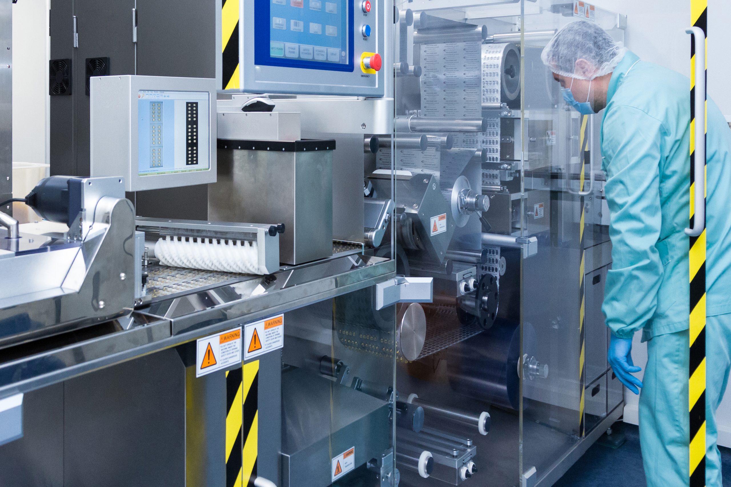 Pharmaceutical factory workers in sterile environment PackStation (SAP)