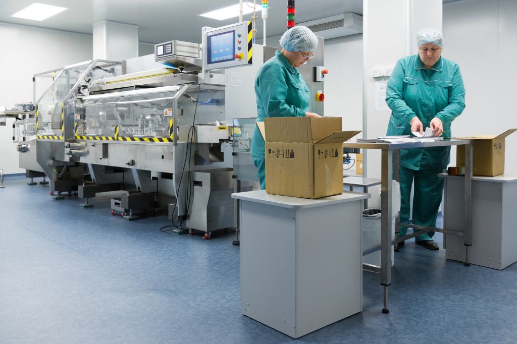 Pharmaceutical factory workers in sterile environment CartonPro