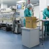 Pharmaceutical factory workers in sterile environment CartonPro